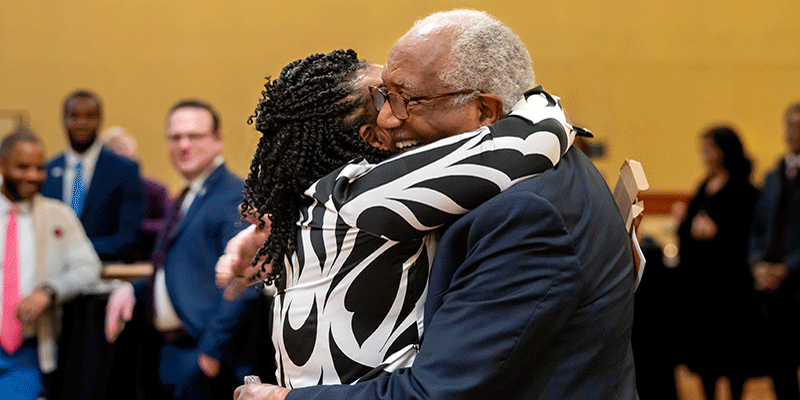 bushell hugs chancellor isaac