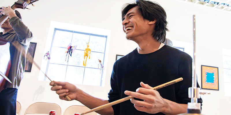 student playiing drums