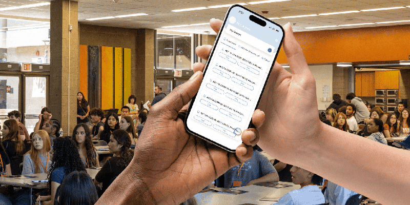 hands holding phone with students in background