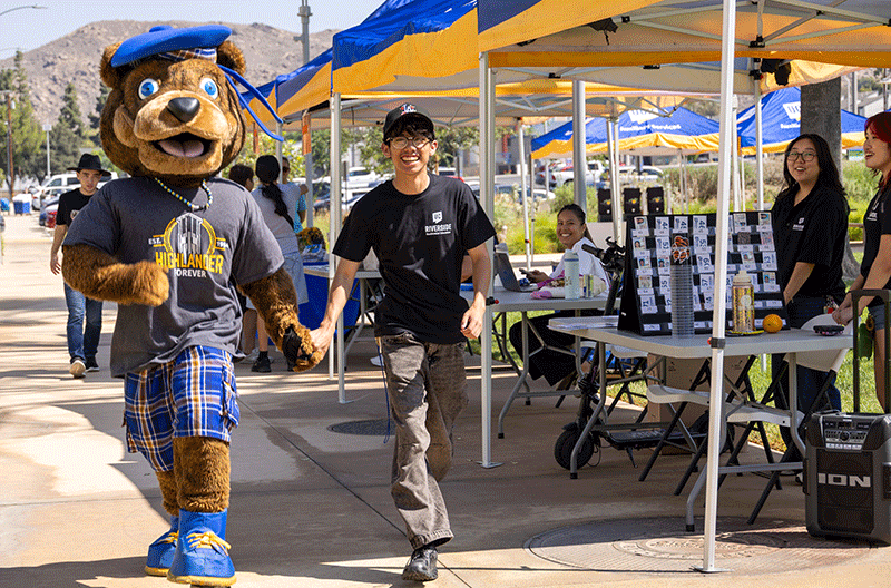 mascot and student walking